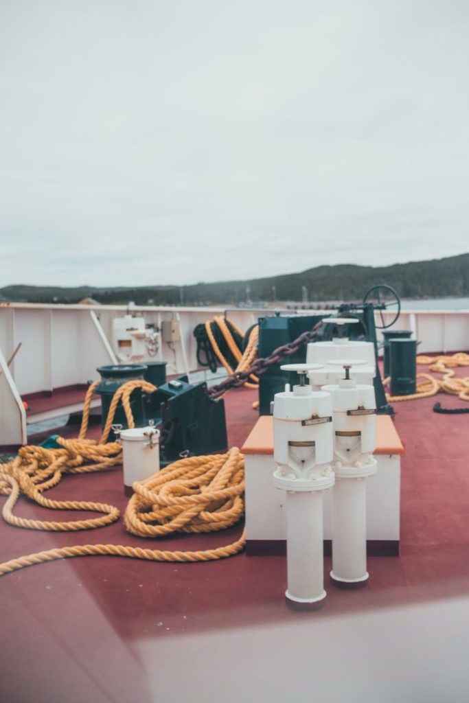 View of a ship deck with ropes and docking equipment, showcasing maritime elements.